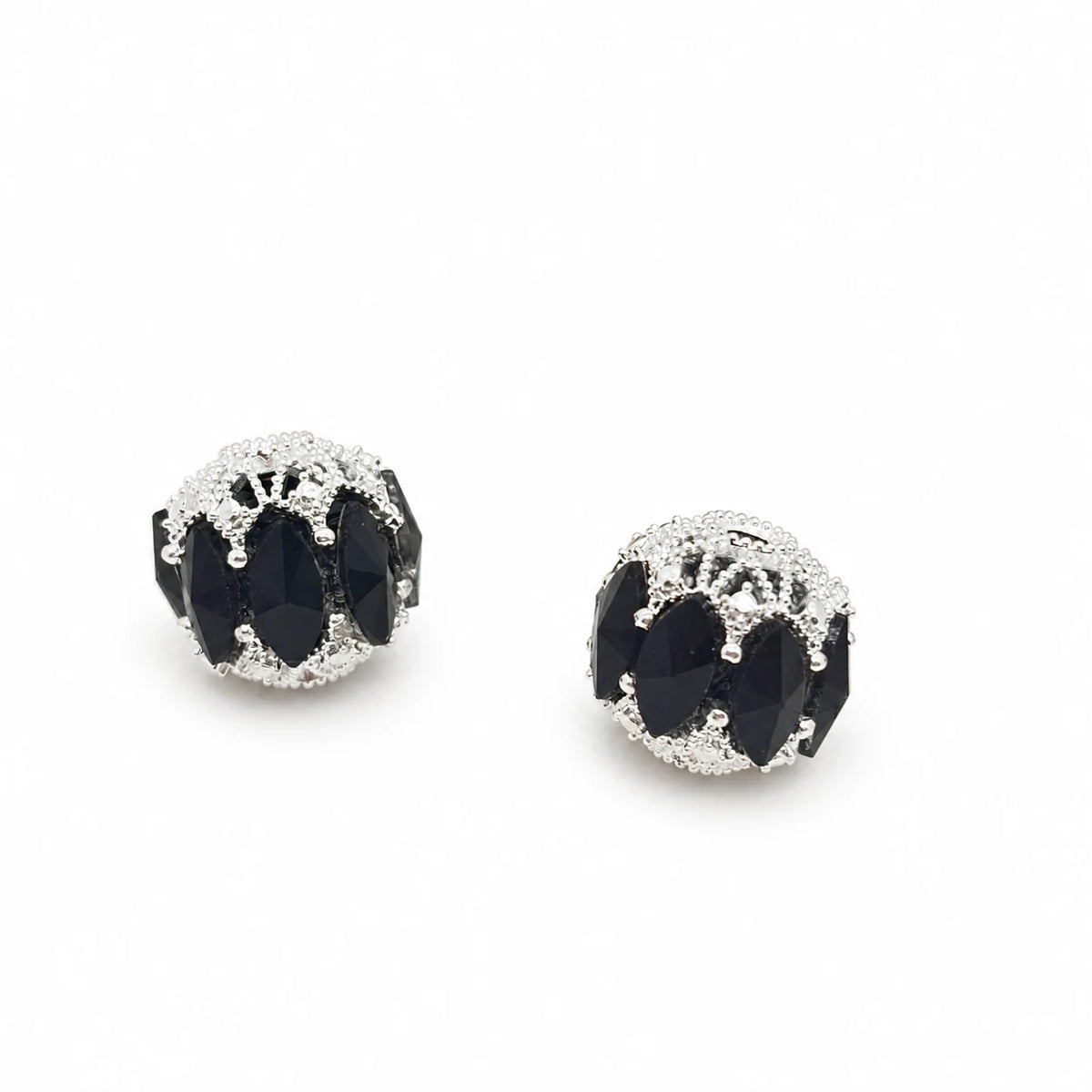 Black filigree focal beads with marquise-shaped accents and silver-tone detailing